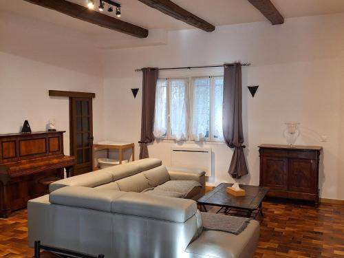 a living room with a couch and a table at La Maison du Moulin de Tartay in Avignon