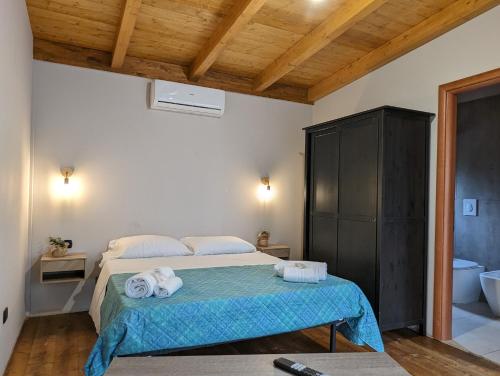 a bedroom with a bed with towels on it at Fattoria Il Laghetto in Lamezia Terme