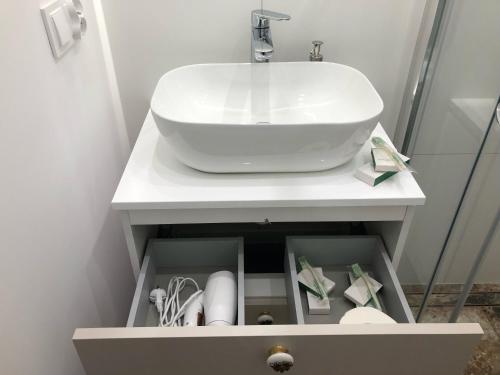łazienka z białą umywalką w szafce w obiekcie Sands Sopot Apartments 1a w mieście Sopot