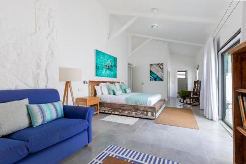 a living room with a bed and a blue couch at 3 Bedroom Villa with pool and garden in Grand Baie in Grand-Baie