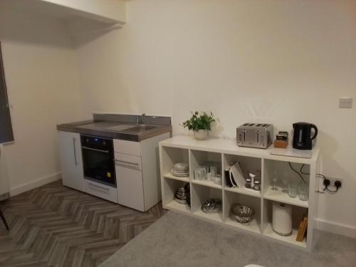 a kitchen with a stove and a counter top at 14 Plants Yard in Worksop