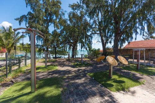 a park with surfboards on display in front of the water at Quaint 4-bedroom Beach Villa in a fishing village in Grand Gaube