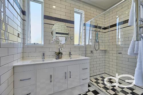 a white bathroom with a sink and a mirror at Federal Apartments South Fremantle in South Fremantle