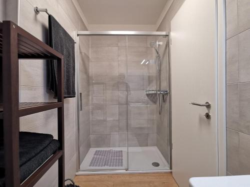 a shower with a glass door in a bathroom at LOFT 18! Cozy loft downtown near the lake with FREE PARKING in Lugano