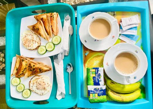 a lunch box with a tray of food and a cup of coffee at Airport Faith Hotel in Katunayake