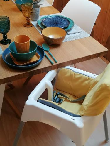 a table with plates and bowls on top of it at Alpenblumal in Bad Goisern