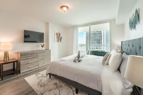 a bedroom with a large bed and a television at Bay Front Highrise Oasis in Brickell in Miami