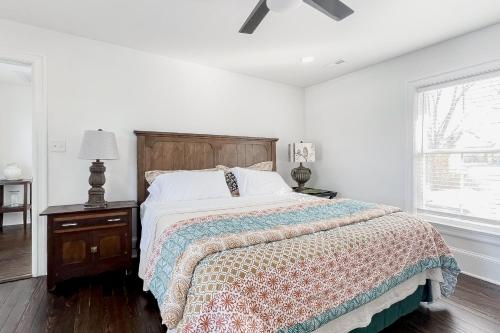 a white bedroom with a bed and a ceiling fan at Historic Culpeper Farmhouse in Culpeper
