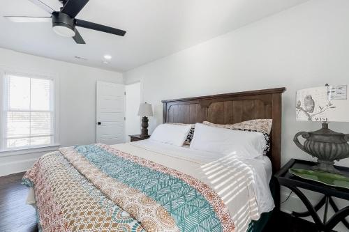 a bedroom with a bed and a ceiling fan at Historic Culpeper Farmhouse in Culpeper