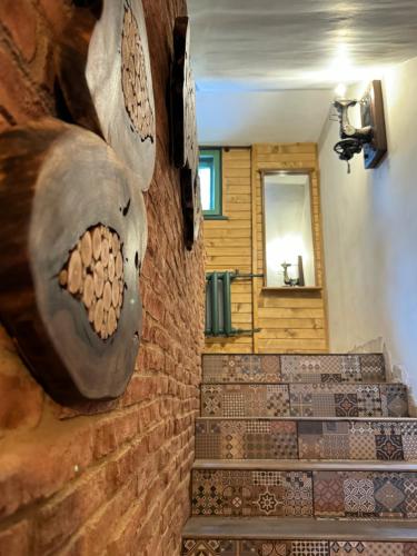 a set of stairs with a sculpture on the wall at Villa Adis with Hot Pool & Jacuzzi by BookVillaBG in Borovets
