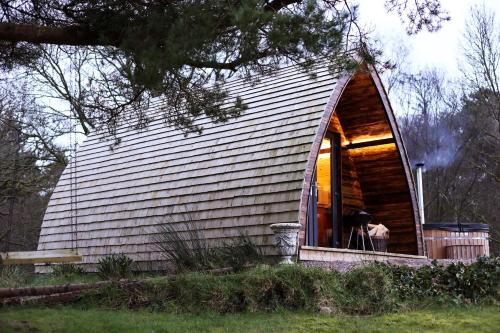 a person sitting in a window of a small house at Tempo Manor Cabins in Tempo