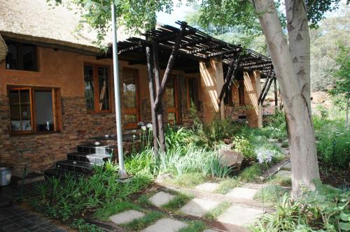 a brick house with a wooden pergola at Sherewood Lodge in Pretoria