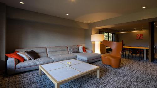 a living room with a couch and a table at Sengokubara COCON in Hakone