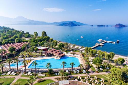 an aerial view of a resort with a pool and the ocean at Club Tuana Fethiye - All Inclusive in Fethiye