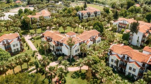 an aerial view of a mansion with palm trees at Club Tuana Fethiye - All Inclusive in Fethiye
