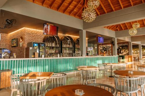 a restaurant with tables and chairs and a bar at Club Tuana Fethiye - All Inclusive in Fethiye