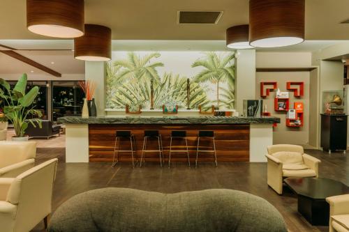 a lobby with a bar with stools and chairs at Club Tuana Fethiye - All Inclusive in Fethiye