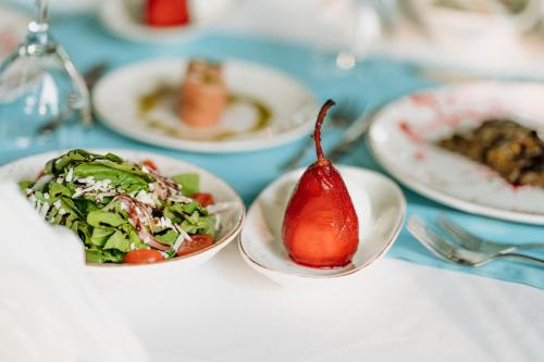 a plate of food with a pomegranate on a table at Club Tuana Fethiye - All Inclusive in Fethiye