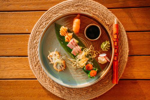 a plate of food with vegetables on a table at Club Tuana Fethiye - All Inclusive in Fethiye