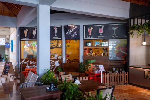 a restaurant with tables and chairs and signs on the wall at Club Tuana Fethiye - All Inclusive in Fethiye