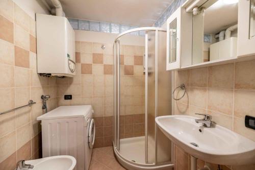 a bathroom with a shower and a toilet and a sink at Residence Arnica in Celledizzo