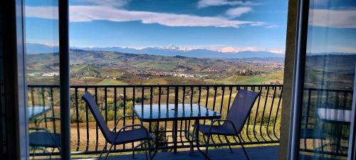 a table and chairs on a balcony with a view at Villa Bellavista Alba, B&B in Alba