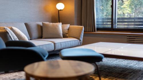 a living room with a couch and chairs and a table at Sengokubara COCON in Hakone
