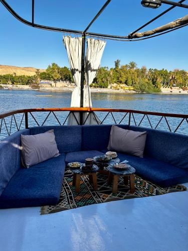 a blue couch sitting on the back of a boat at Houseboat Hotel and Nile Cruises Zainoba in Nag` el-Ramla