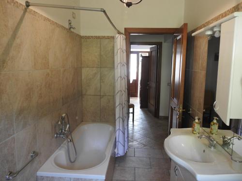 a bathroom with a tub and a sink at La Fattoria dei Sibillini in Montemonaco