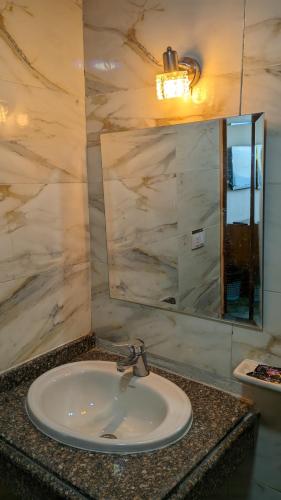 a bathroom with a sink and a mirror at Royal Crown Hotel عائلات فقط in Alexandria