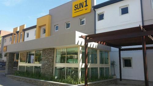 a building with a sun sign on the side of it at SUN1 PRETORIA in Pretoria