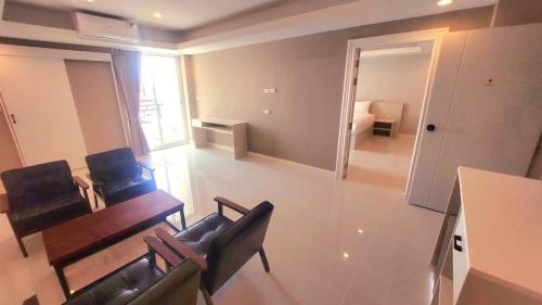 uma sala de estar com cadeiras, uma mesa e um sofá em PKK hotel Residence em Bang Phli