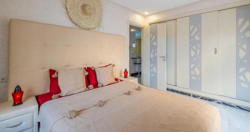 a bedroom with a large bed with a large mirror at AiM HOUSE in Marrakech