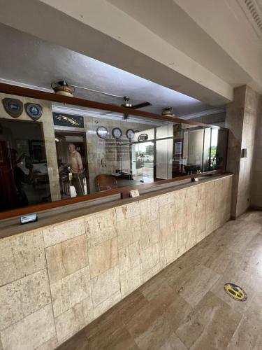 a restaurant with a bar with mirrors on the wall at Hotel Tropicana Santo Domingo in La Viva