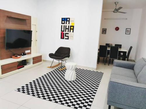 a living room with a couch and a tv at IPOH BOTANI bauhaus 17pax/4BR/mahjong/tv box in Ipoh