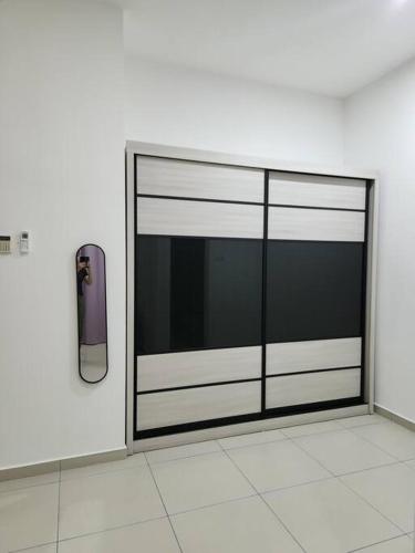 a sliding glass door with a phone on a wall at IPOH BOTANI bauhaus 17pax/4BR/mahjong/tv box in Ipoh