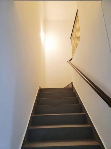 a staircase in a building with a stair case at IPOH BOTANI bauhaus 17pax/4BR/mahjong/tv box in Ipoh