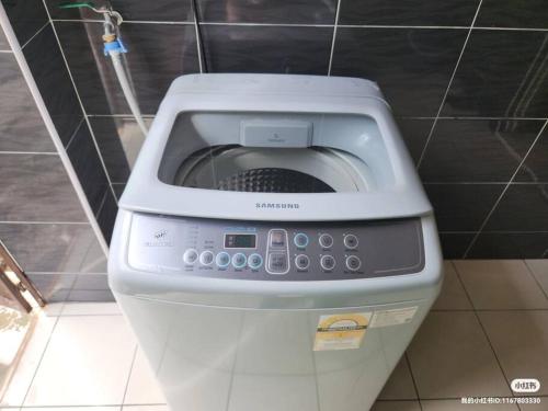 a washing machine sitting on top of a toilet at IPOH BOTANI bauhaus 17pax/4BR/mahjong/tv box in Ipoh