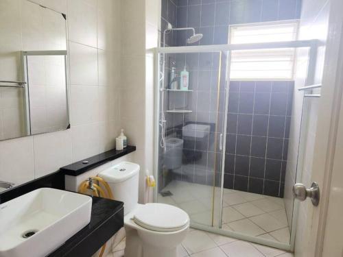 a bathroom with a shower and a toilet and a sink at IPOH BOTANI bauhaus 17pax/4BR/mahjong/tv box in Ipoh