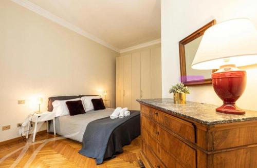 a bedroom with a bed and a table with a lamp at Milano Cordusio in Milan