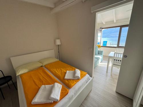 a bedroom with a bed with two towels on it at Lakeview Cannobio Camping & Resort in Cannobio