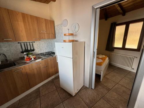 a kitchen with a white refrigerator and a sink at Lakeview Cannobio Camping & Resort in Cannobio