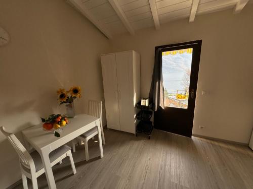 a room with a table and chairs and a window at Lakeview Cannobio Camping & Resort in Cannobio