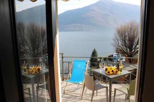 a table and chairs on a balcony with a view of a lake at Lakeview Cannobio Camping & Resort in Cannobio