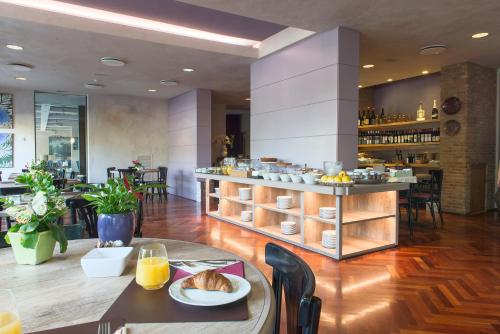 a restaurant with a counter with food on it at San Paolo Hotel in Montegiorgio