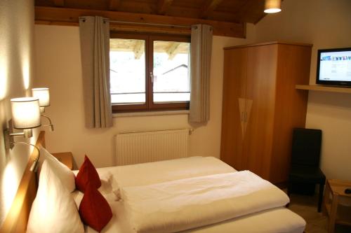a hotel room with a bed and a window at Tirolerhof - Appartementhaus in Kaunertal