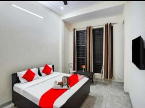 a bedroom with a large bed with red pillows at Heaven Stay in Greater Noida