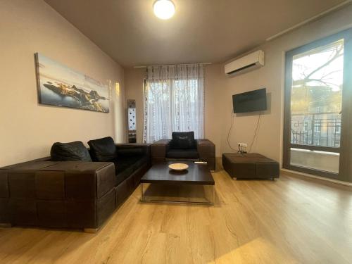 a living room with a couch and a coffee table at 3 стаен апартамент идеален център Варна in Varna City