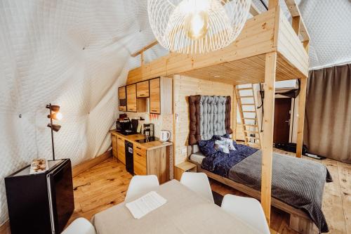 a bedroom with a bed and a desk in a room at Karkonoski Glamping in Łomnica