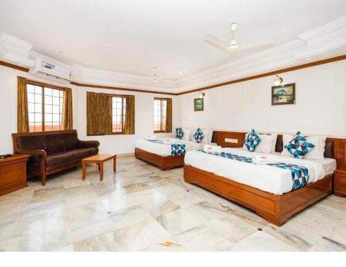 a large room with two beds and a couch at HOTEL GALAXY SURAT in Surat